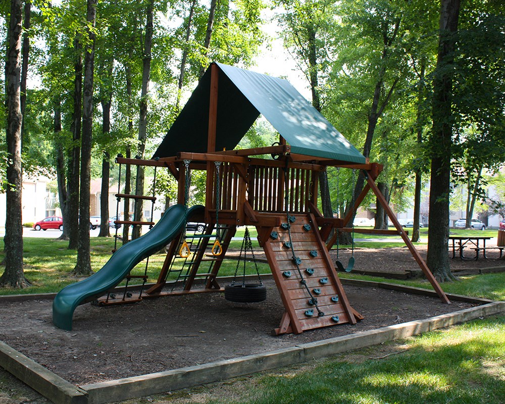 a swing set with a slide in a park  at Hunter's Creek Apartments, Cincinnati, OH, 45242