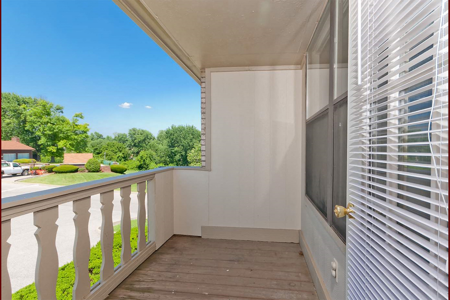 a balcony with a view of a yard and a door to a balcony  at Four Worlds Apartments, Cincinnati, OH, 45231