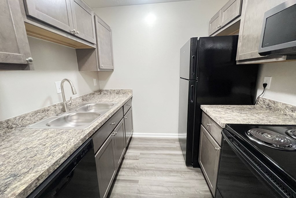 a kitchen with stainless steel appliances and marble counter tops at Revere Village Apartments, Centerville, OH, 45458