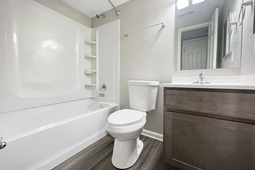 a bathroom with a toilet and a tub and a sink at Revere Village Apartments, Ohio, 45458