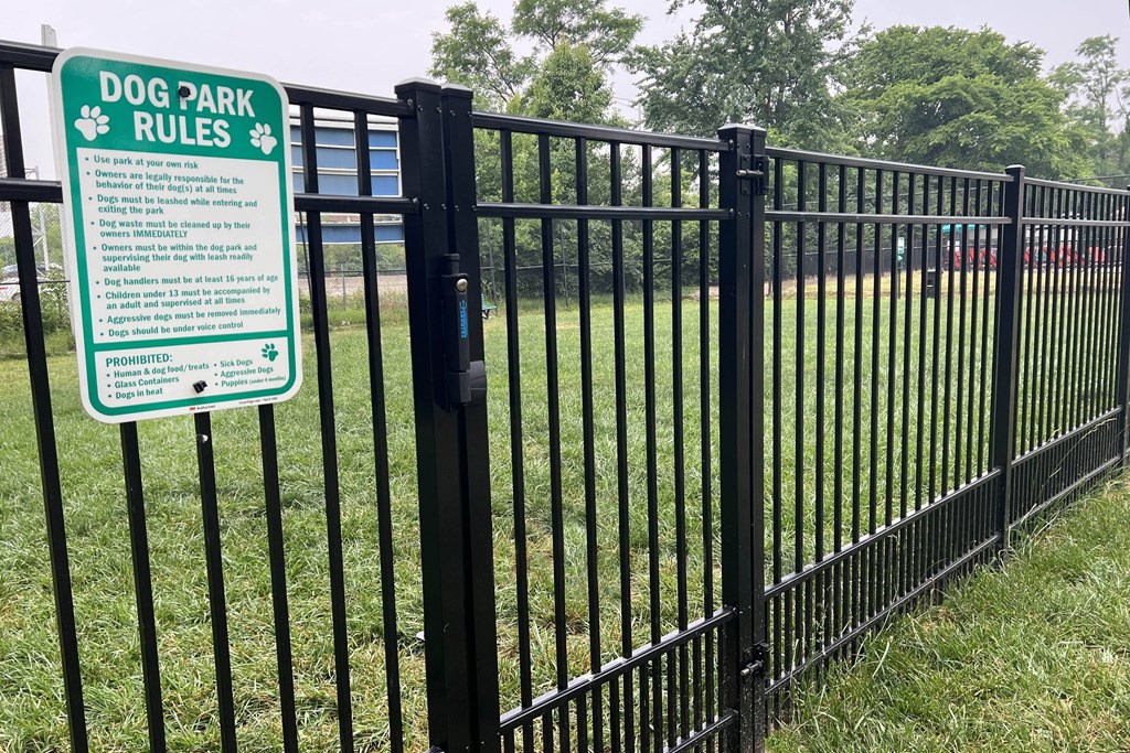 a black fence with a sign that says dog park rules  at Hunter's Creek Apartments, Cincinnati, OH, 45242