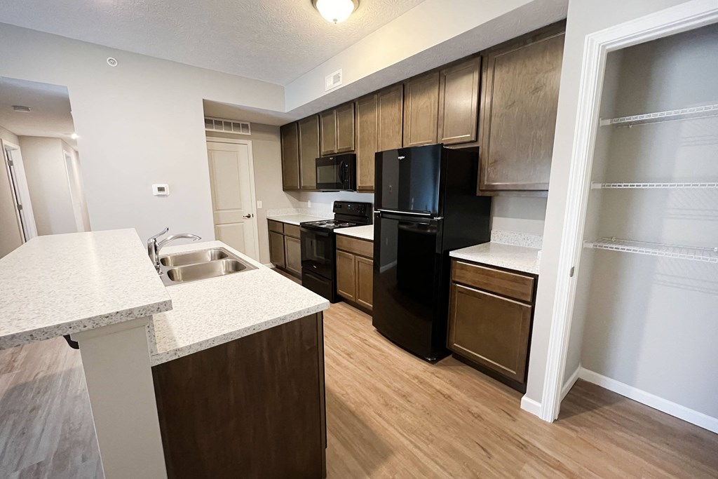 a kitchen with black appliances and wooden cabinets  at Brookfield Village Apartments, Grove City, OH, 43123