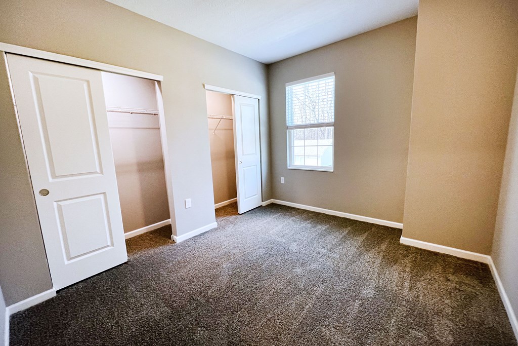 an empty room with two closets and a window  at Brookfield Village Apartments, Ohio