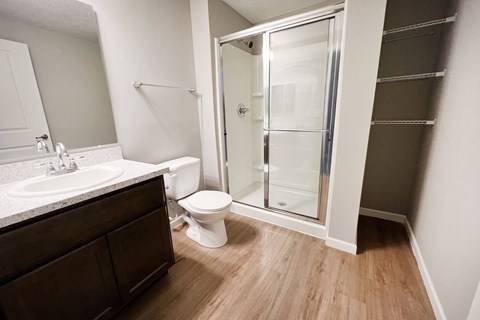 an empty bathroom with a shower toilet and sink  at Brookfield Village Apartments, Ohio, 43123