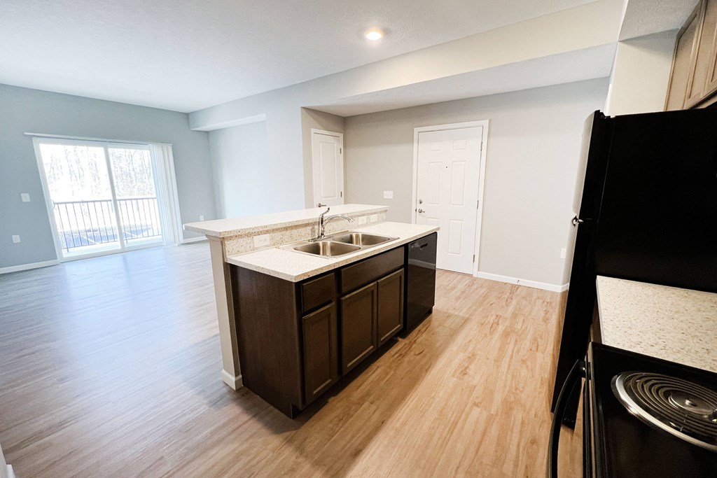 an empty kitchen and living room with wood flooring and a window  at Brookfield Village Apartments, Ohio, 43123