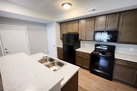 a kitchen with black appliances and white counter tops  at Brookfield Village Apartments, Grove City, OH, 43123