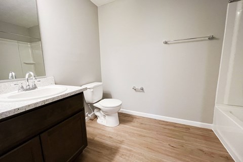 an empty bathroom with a toilet and a sink  at Brookfield Village Apartments, Grove City
