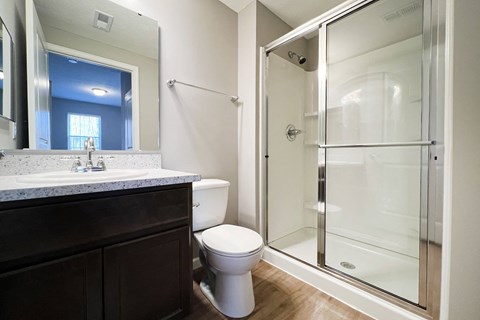 a bathroom with a shower and a sink and a toilet at Brookfield Village in Grove City, OH