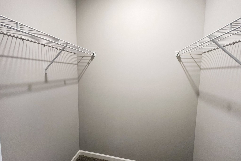 an empty closet with two shelves in a room with white walls  at Brookfield Village Apartments, Ohio, 43123