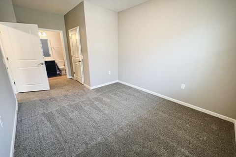 an empty living room with carpeting and white walls  at Brookfield Village Apartments, Ohio