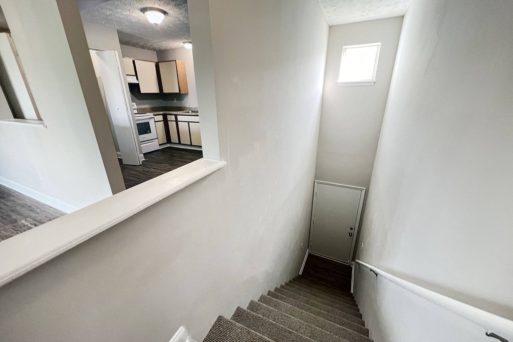 a stairwell in a home with white walls and a kitchen at 450 on Keeneland Apartments, Richmond, 40475