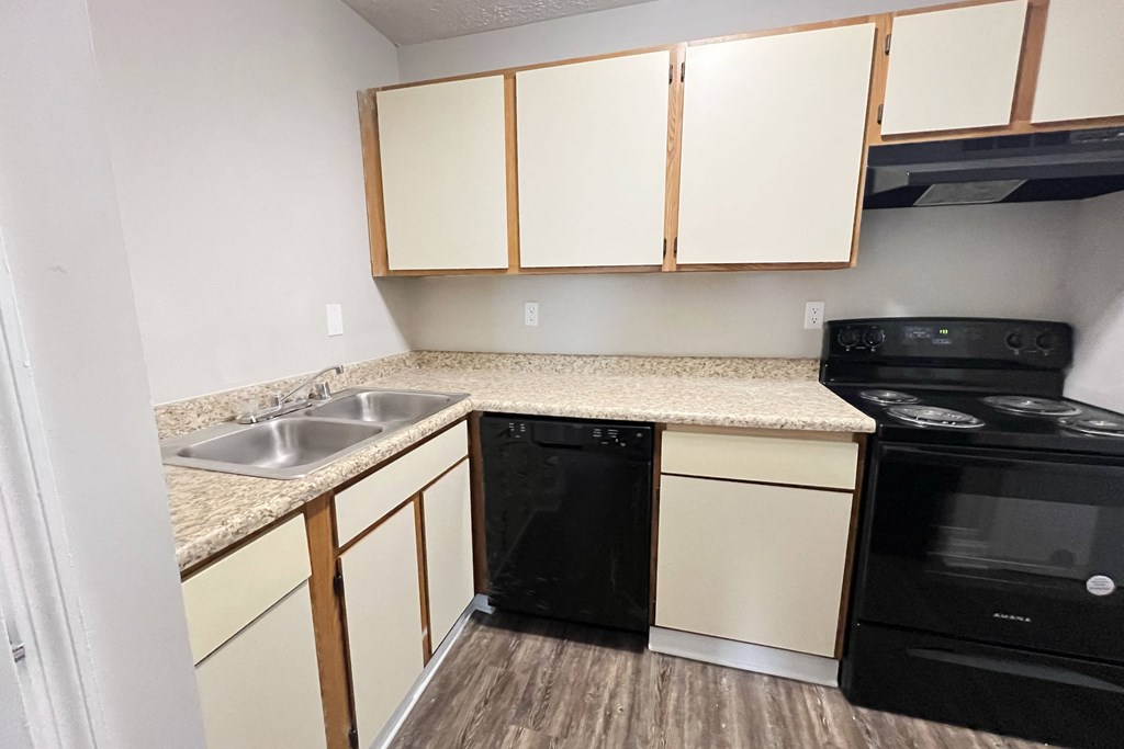 Kitchen with white cabinets and black appliances at 450 on Keeneland Apartments, Richmond