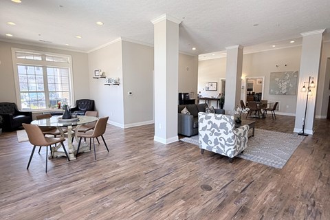 A living room with a dining table and chairs.