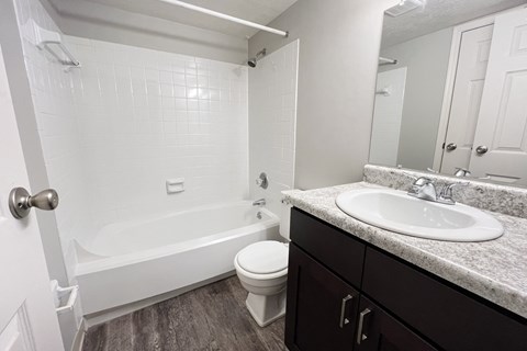an empty bathroom with a sink toilet and bath tub at Crown Crossing Apartments, Amelia, OH, 45102
