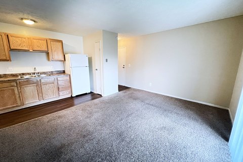 A kitchen with wooden cabinets and a white refrigerator at Crown Crossing Apartments, Amelia, 45102