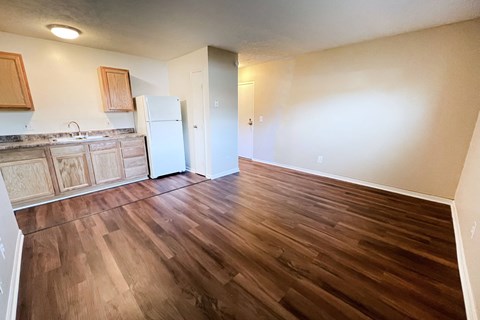 A kitchen with wooden floors and a white refrigerator at Crown Crossing Apartments, Amelia, Ohio, 45102