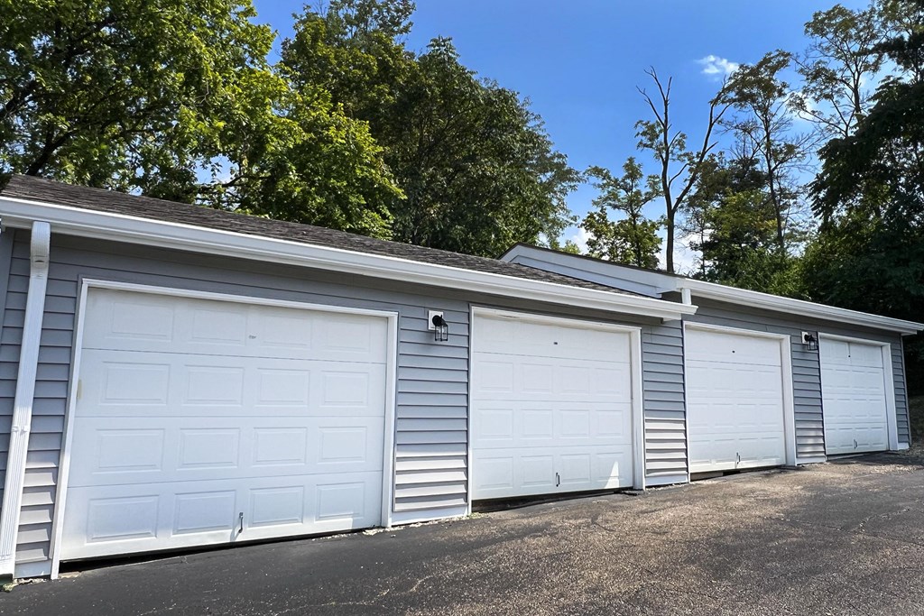 a row of three garage doors on the side of a building at Deercross Apartments, Cincinnati, 45236