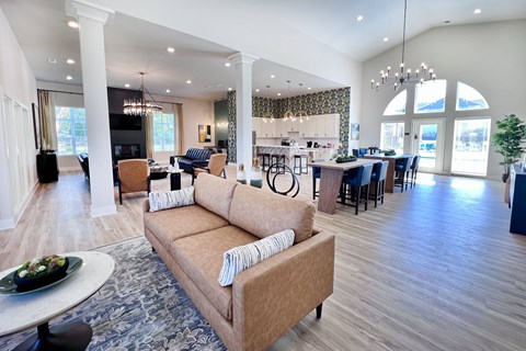 A living room with a couch and a dining table.