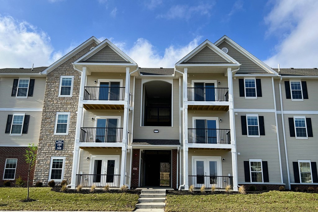 a large apartment building with stairs in front of it