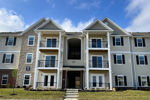 a large apartment building with stairs in front of it