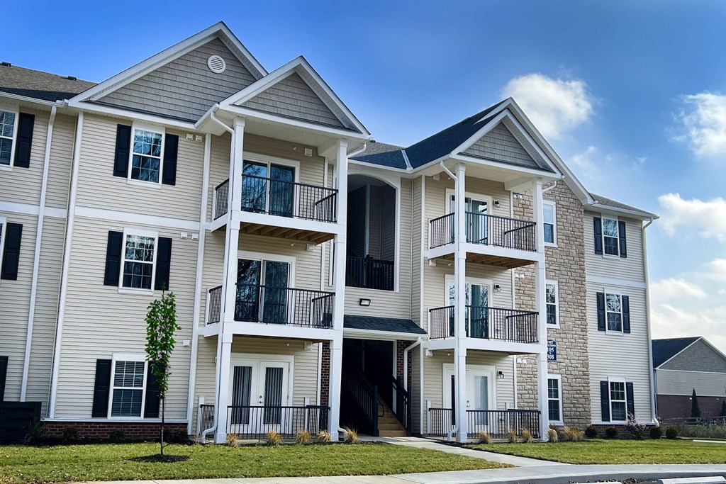 a row of town homes with balconies on a sunny day