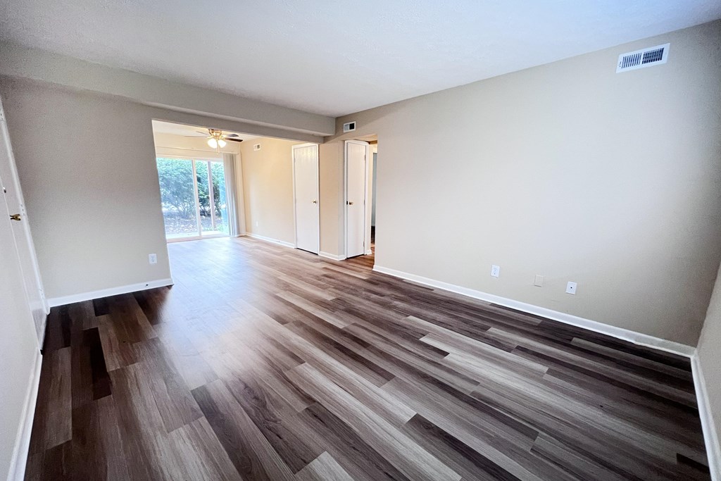 A room with wood flooring and white walls.