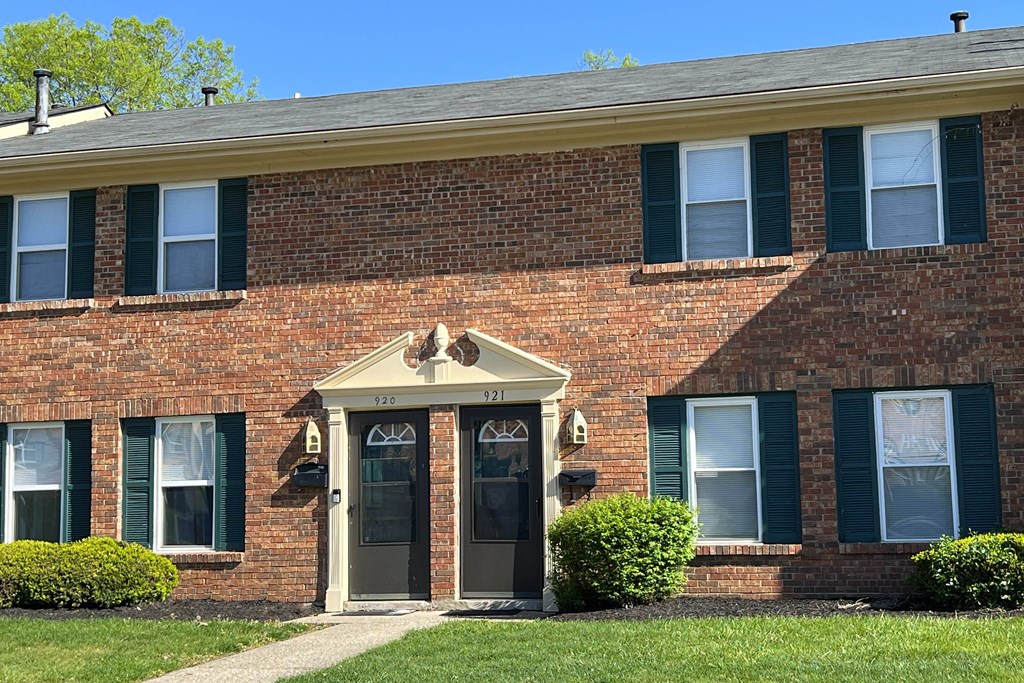 a brick house with green shutters and a front doorat Revere Village Apartments, Centerville