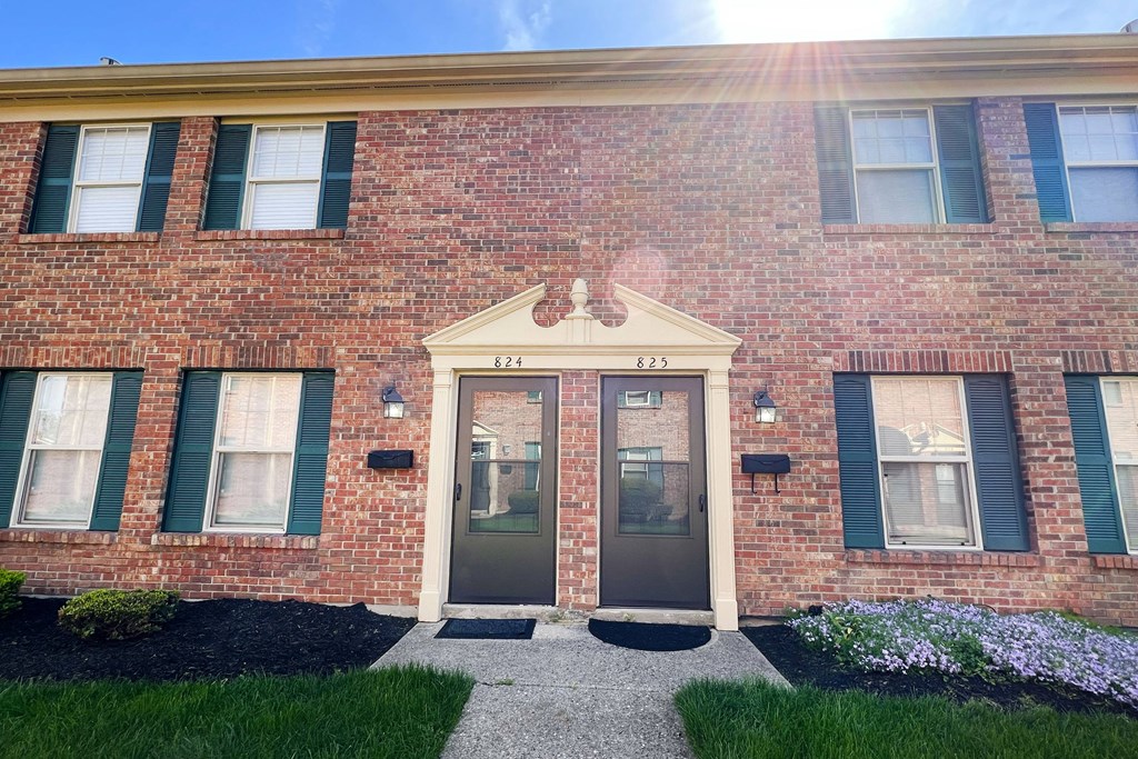 the front of a brick building with two doorsat Revere Village Apartments, Ohio, 45458