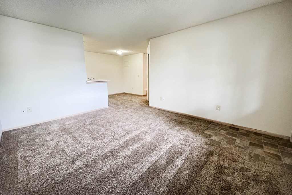 a room with white walls and a multicolored carpet at Eagle Crest Apartments, Galloway, OH 43119
