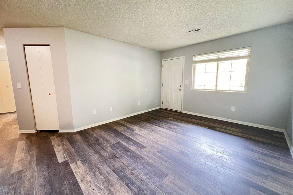 an empty living room with wood flooring and a window at Eagle Crest Apartments, Ohio, 43119