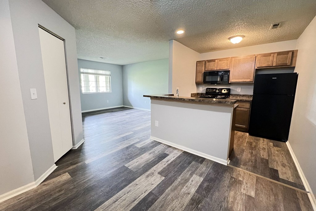 the view of a kitchen and living room in an empty apartment at Eagle Crest Apartments, Ohio