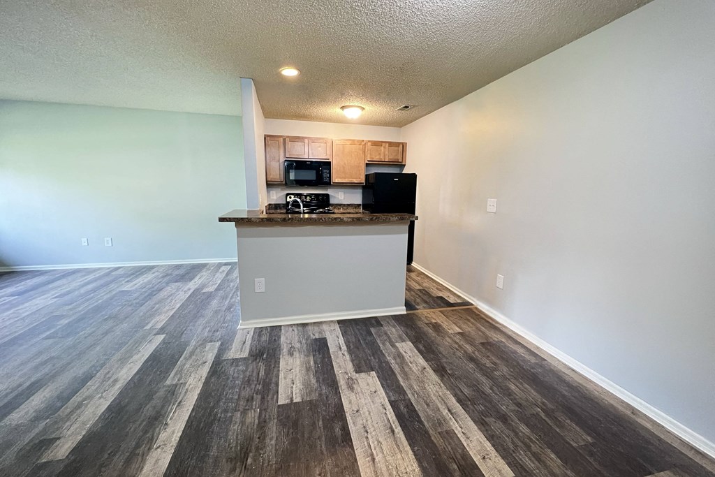 an empty living room and kitchen with a counter top at Eagle Crest Apartments, Galloway, Ohio