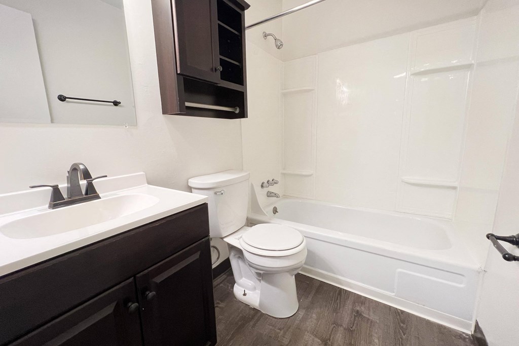 an empty bathroom with a sink toilet and bath tub