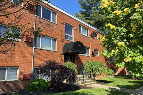 a brick apartment building with a black awning at Crown Court Apartments, Kentucky, 41042