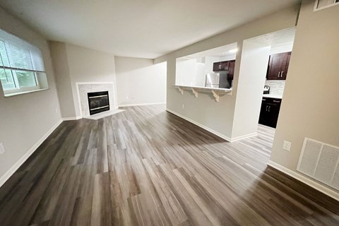 an empty living room with wooden floors and a fireplace at The Vinings Apartments, Cincinnati, 45245