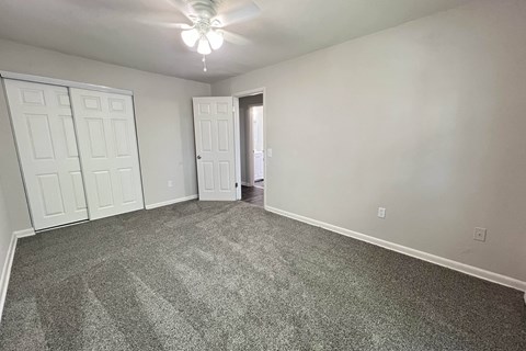 an empty living room with carpet and a ceiling fan at Crown Court Apartments, Kentucky, 41042