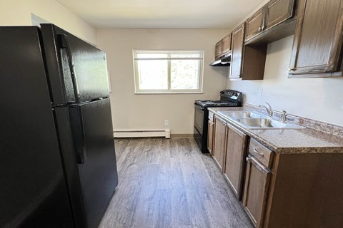 an empty kitchen with a refrigerator and a sink at Crown Court Apartments, Kentucky, 41042