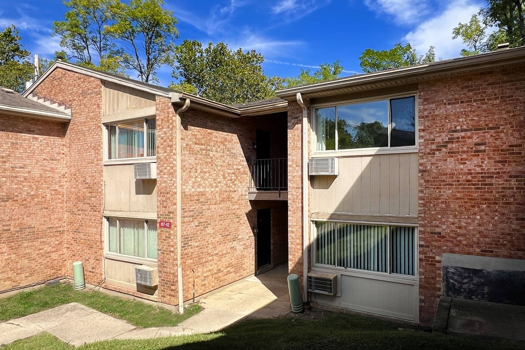 A brick building with a balcony and a door.