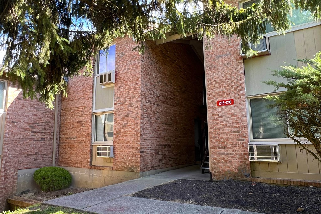 A building entrance with a red sign that says
