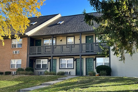 A two-story building with a balcony on the second floor.