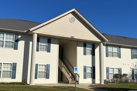 A building with a blue handicap sign in front of it.