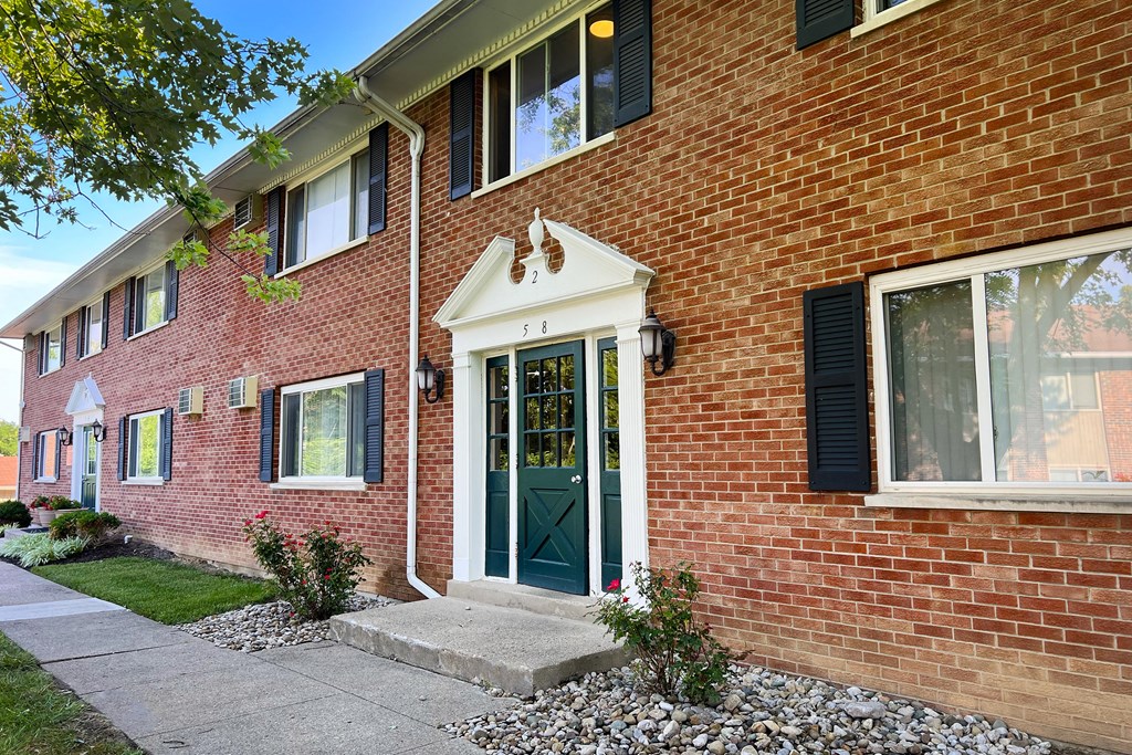 the front of a brick house with a green door at Sharondale Woods Apartments, Ohio, 45241