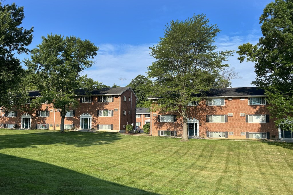 a large lawn in front of a brick apartment building at Sharondale Woods Apartments, Cincinnati, 45241