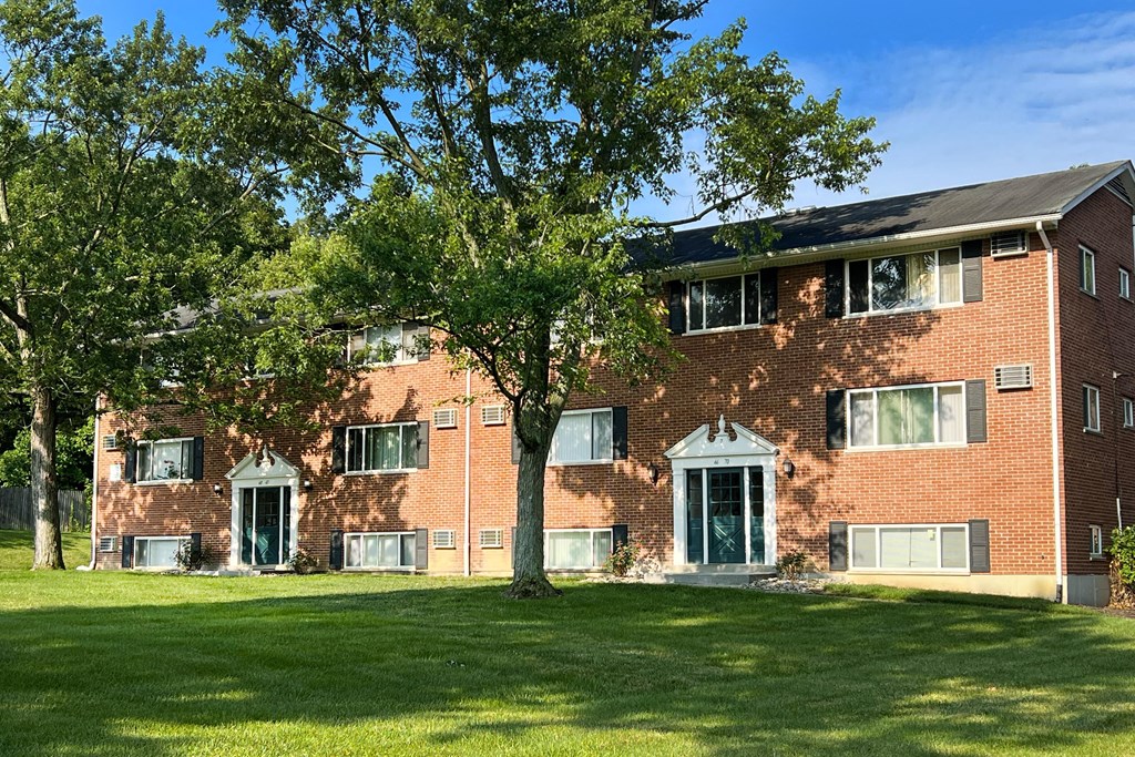 a red brick apartment building with green grass and trees at Sharondale Woods Apartments, Ohio, 45241