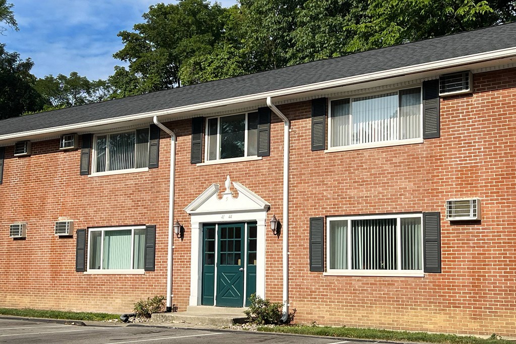 the front of a brick house with a green door at Sharondale Woods Apartments, Ohio, 45241
