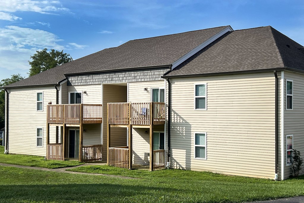 the exterior of a house with a balcony and a yard at 450 on Keeneland Apartments, Richmond