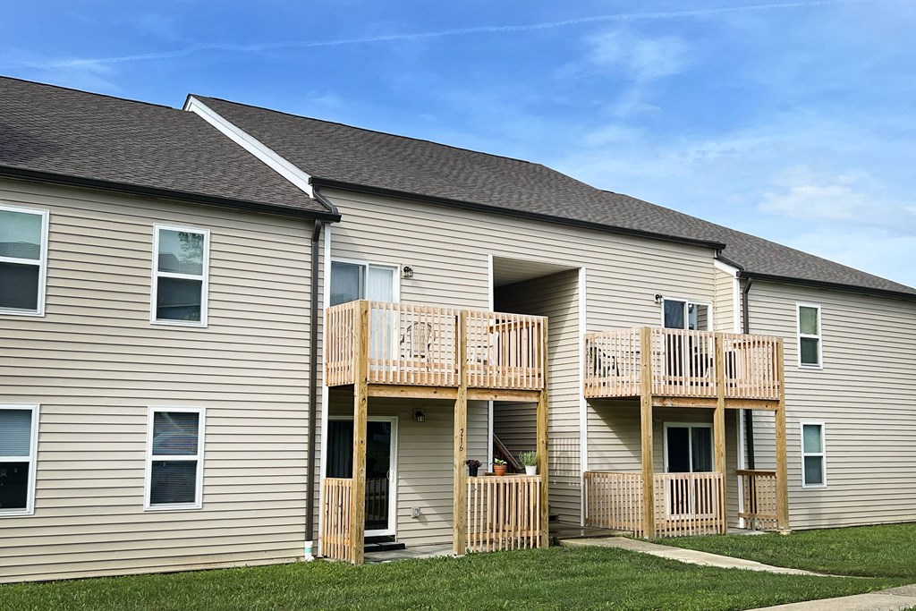 the back of a house with a balcony and a yard at 450 on Keeneland Apartments, Richmond, KY 40475