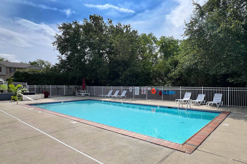 a swimming pool with chairs and a fence around it at 450 on Keeneland Apartments, Richmond, KY 40475