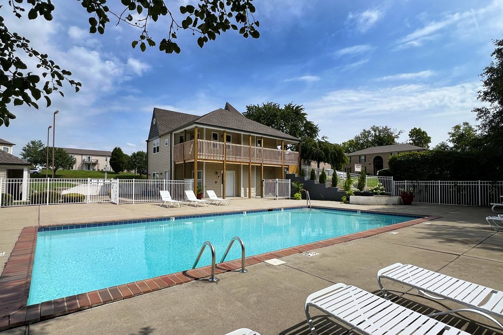 a swimming pool in front of a house at 450 on Keeneland Apartments, Richmond, KY
