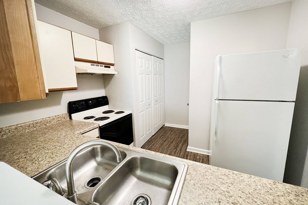 a kitchen with a sink and a refrigerator at 450 on Keeneland Apartments, Kentucky